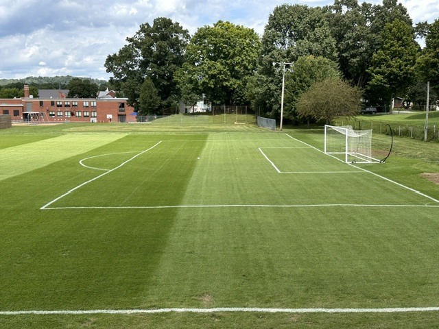Photo of the soccer field after the turf has been laid 