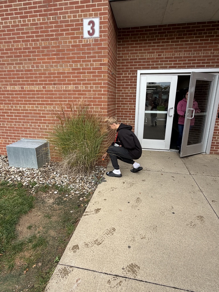 Photo of a student hiding a pumpkin.