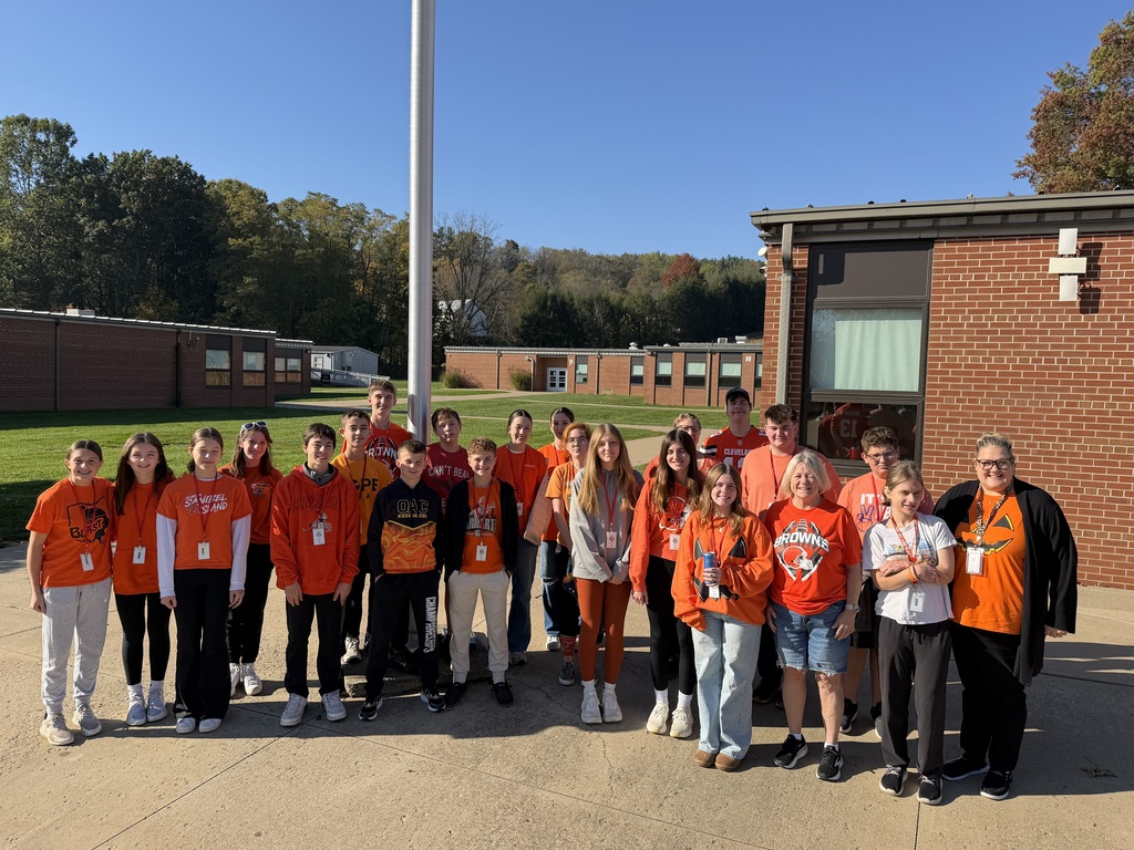 Student group outside of high school wearing orange.
