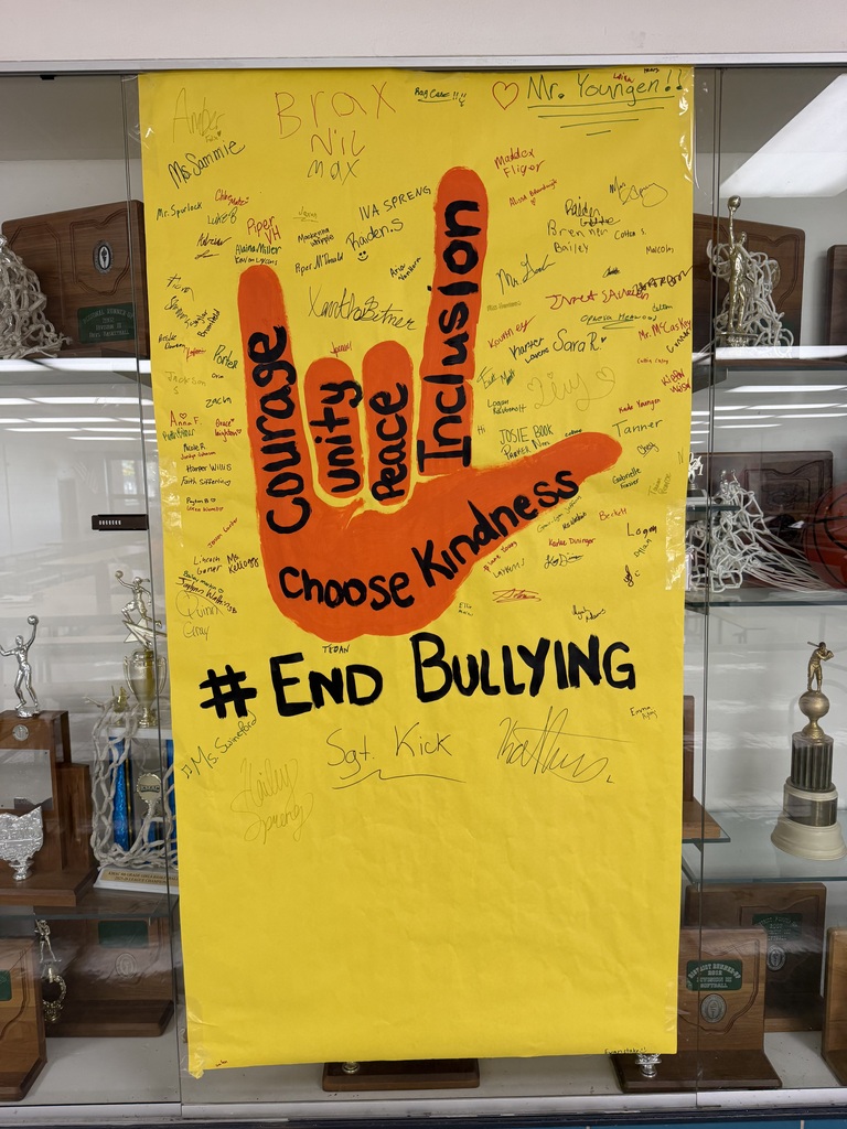 Hand painted sign with the message to "end bullying" with student signatures.