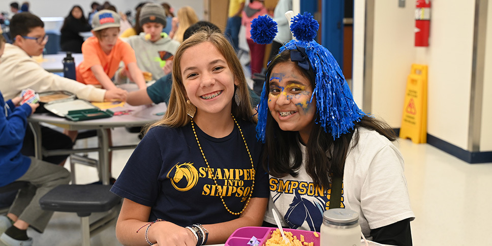 Two female students with Simpson Middle School shirts on