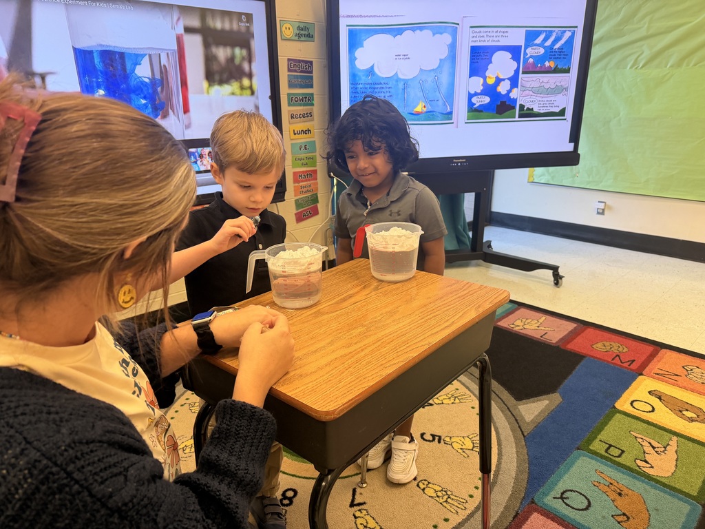 Teacher and two students with two measuring cups