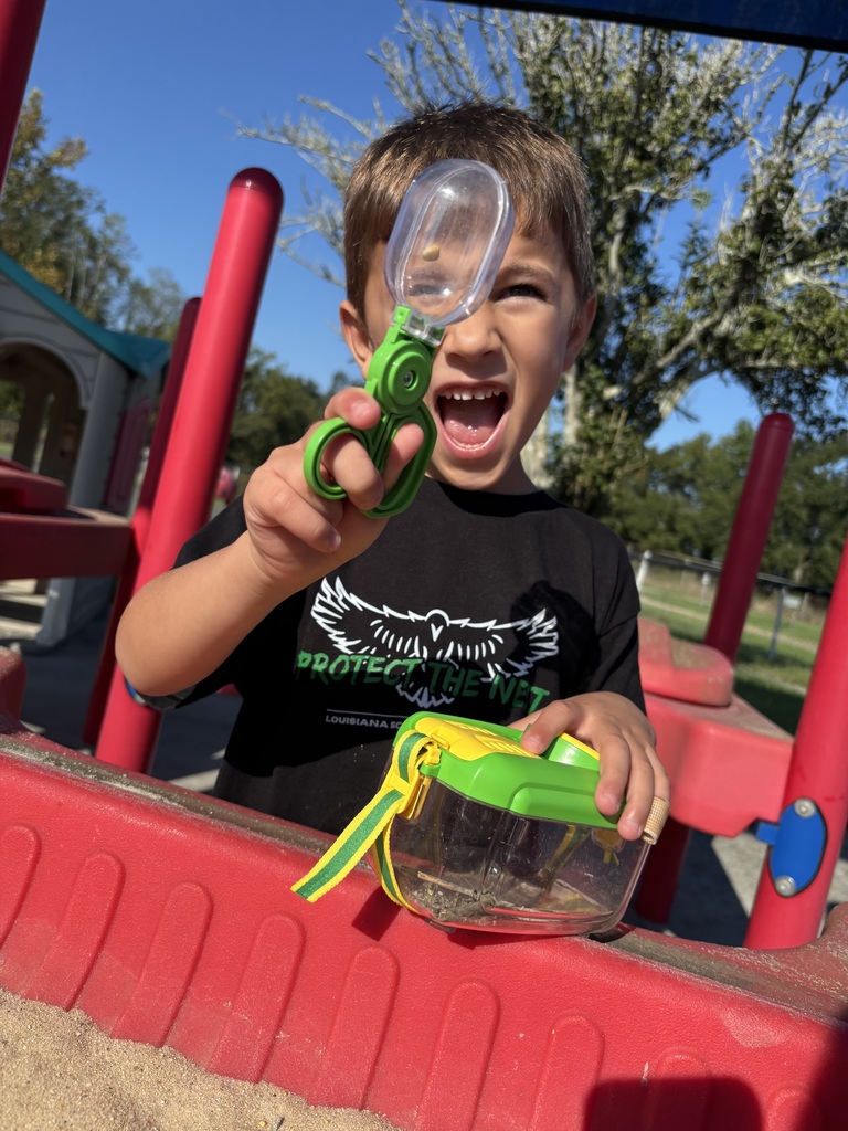 Student holding up a bug holder