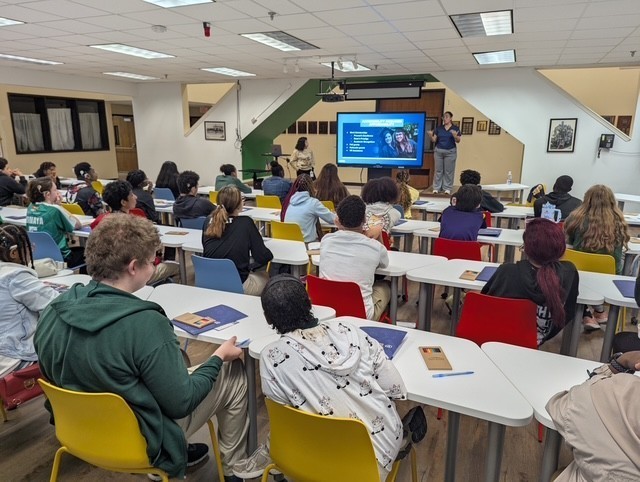 High school students in the common area for a presentation.