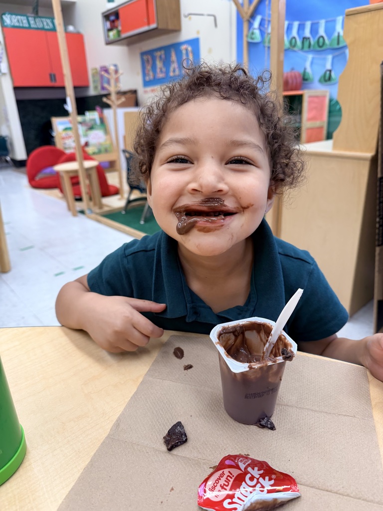 Student eating chocolate pudding