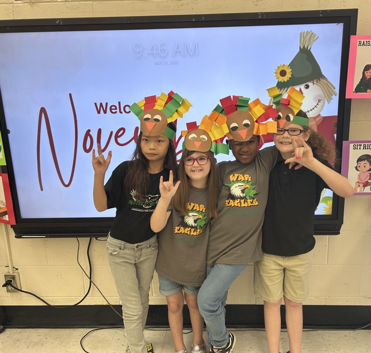 students in front of a board smiling