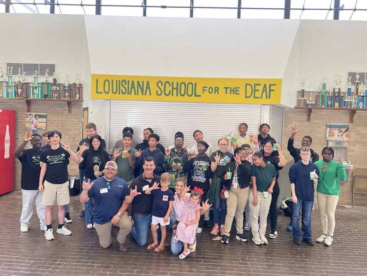 students standing in concession stand area and smiling