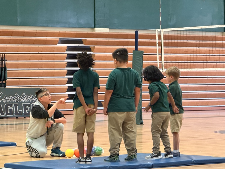 students in gym with PE teacher