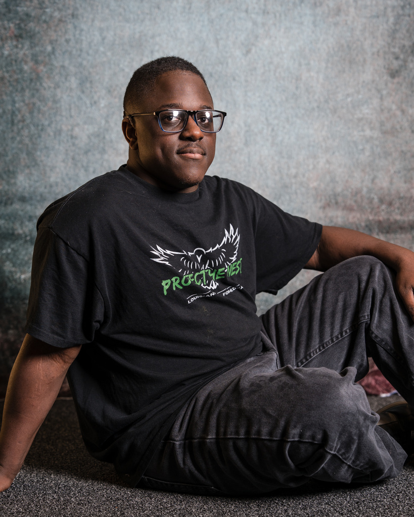 Student posing for a phot on the ground