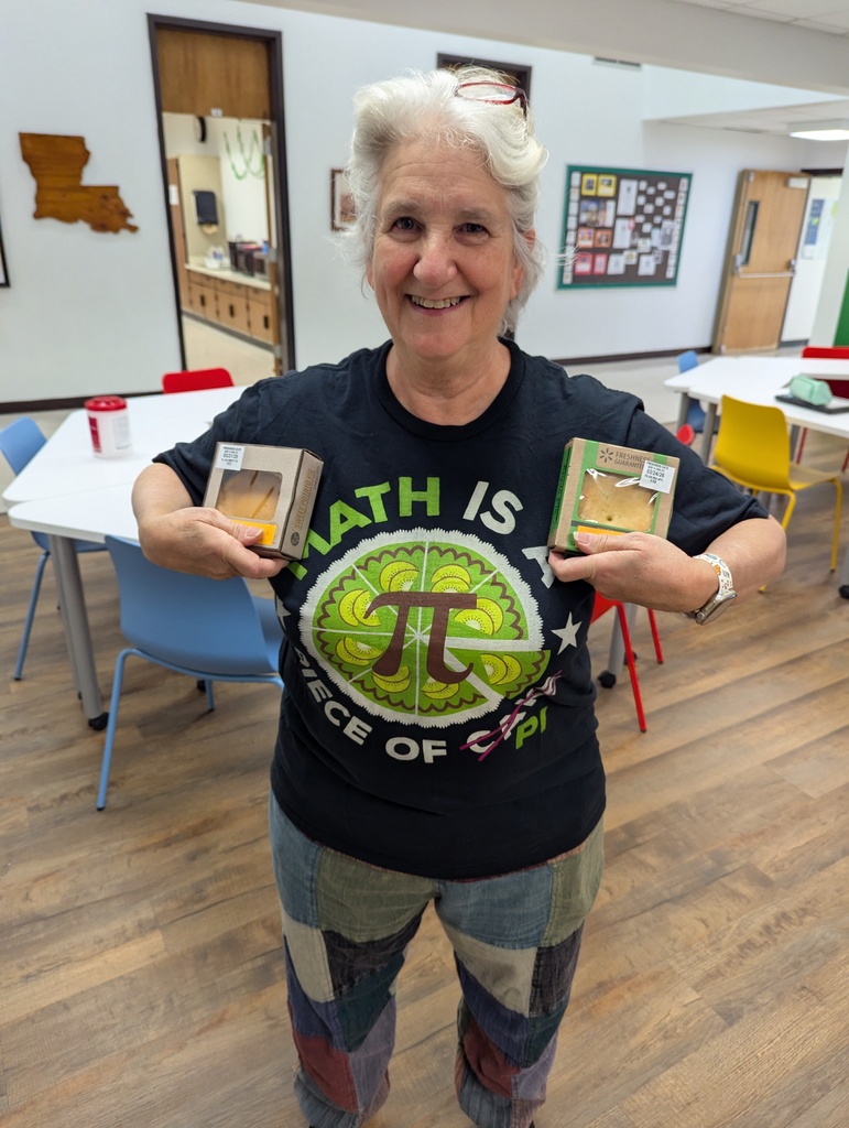 Teacher holding two mini pies