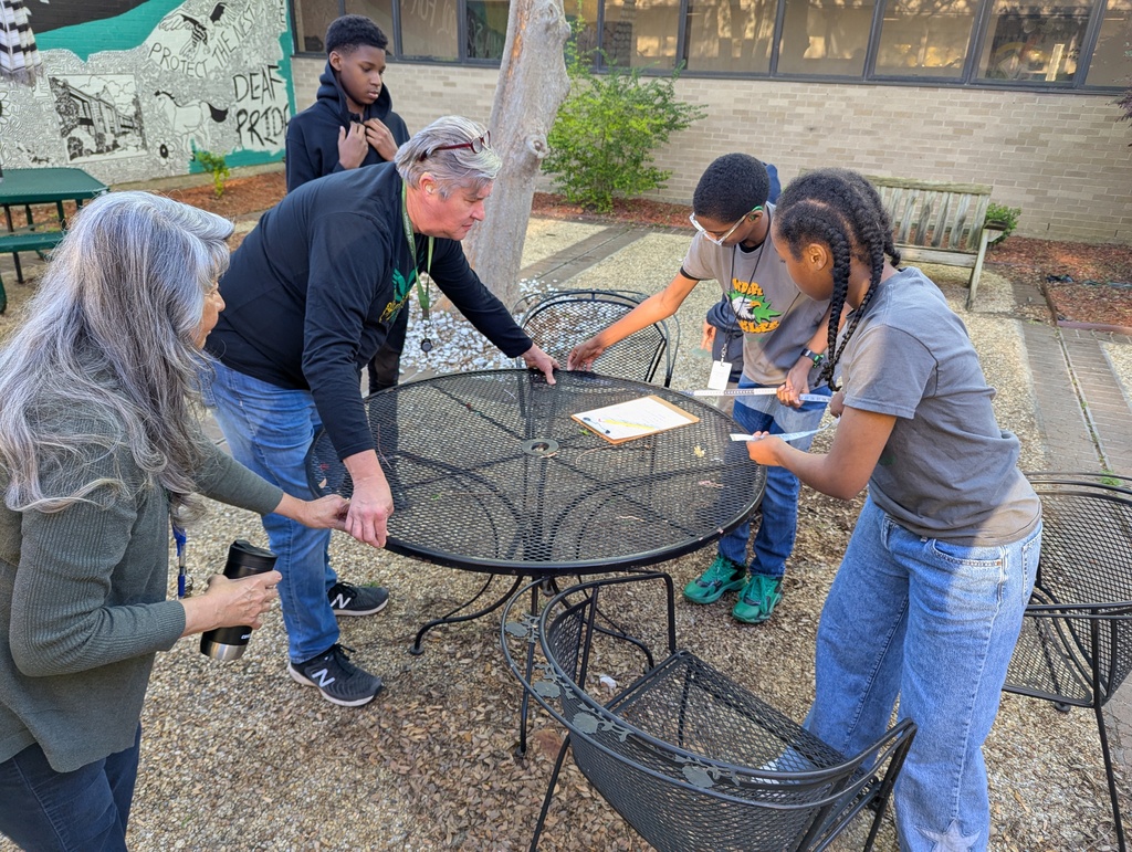 Students outside measuring a table