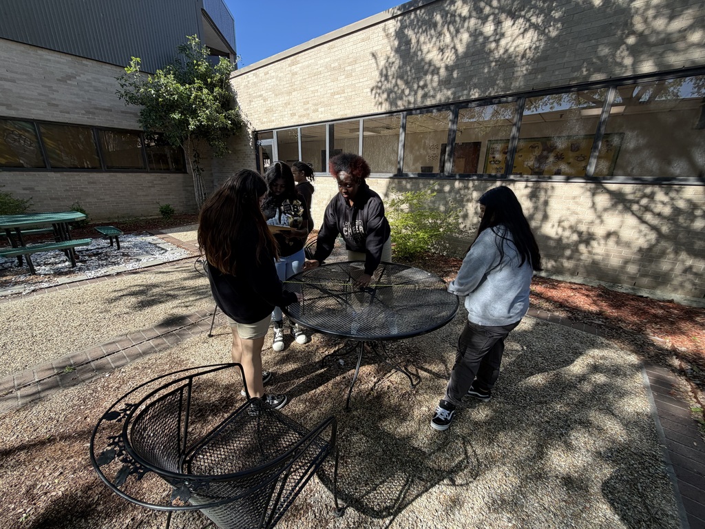 Student outside measuring a table