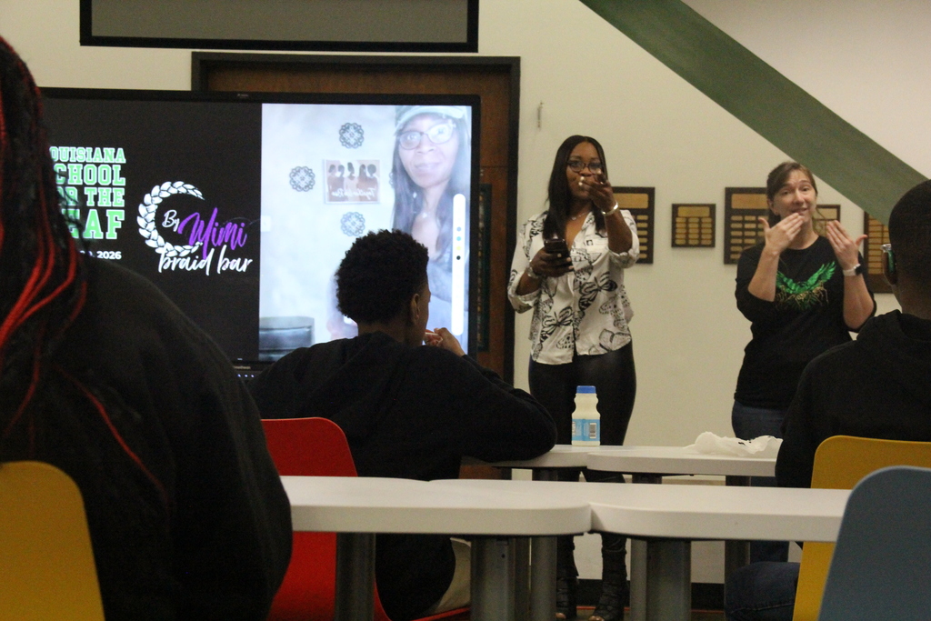 Presenter at the front pointing to someone with a question