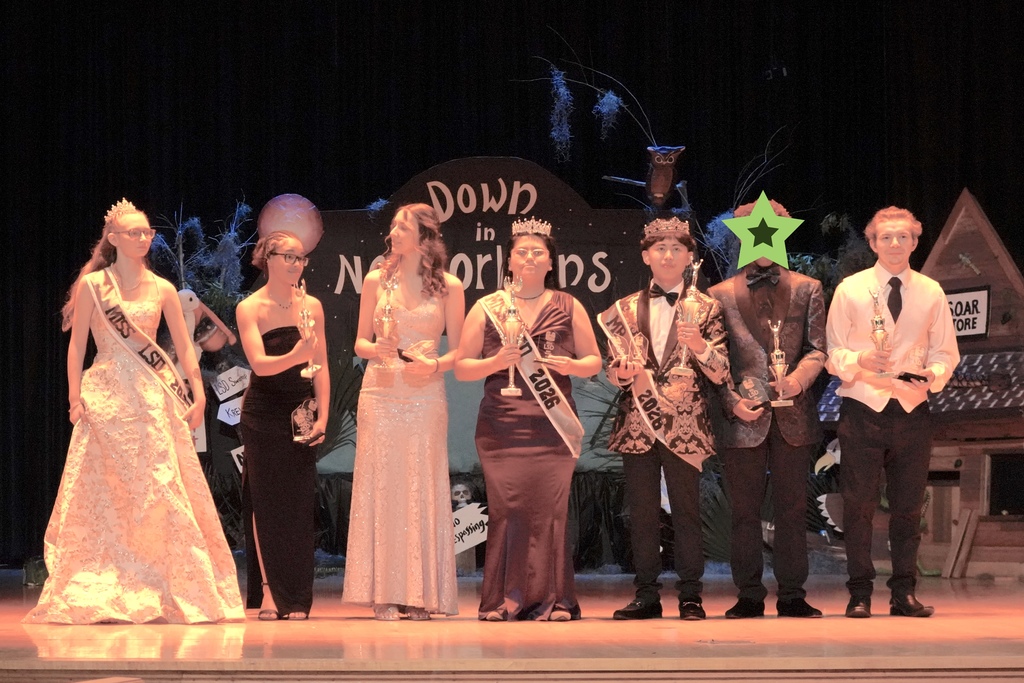 Group on stage with trophies 