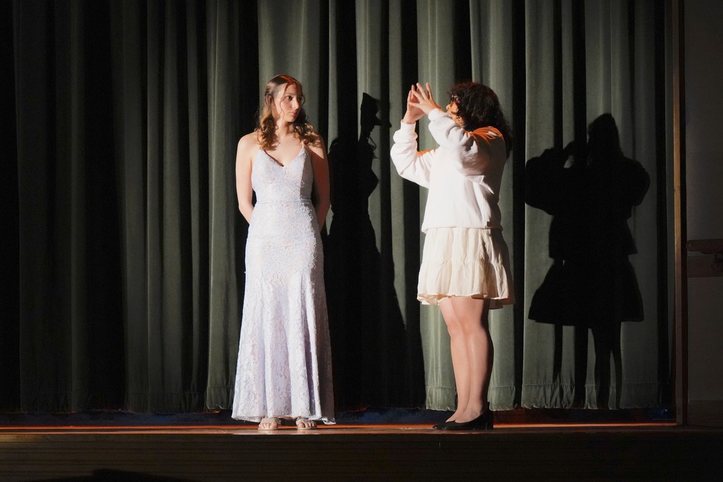 Student and staff on stage