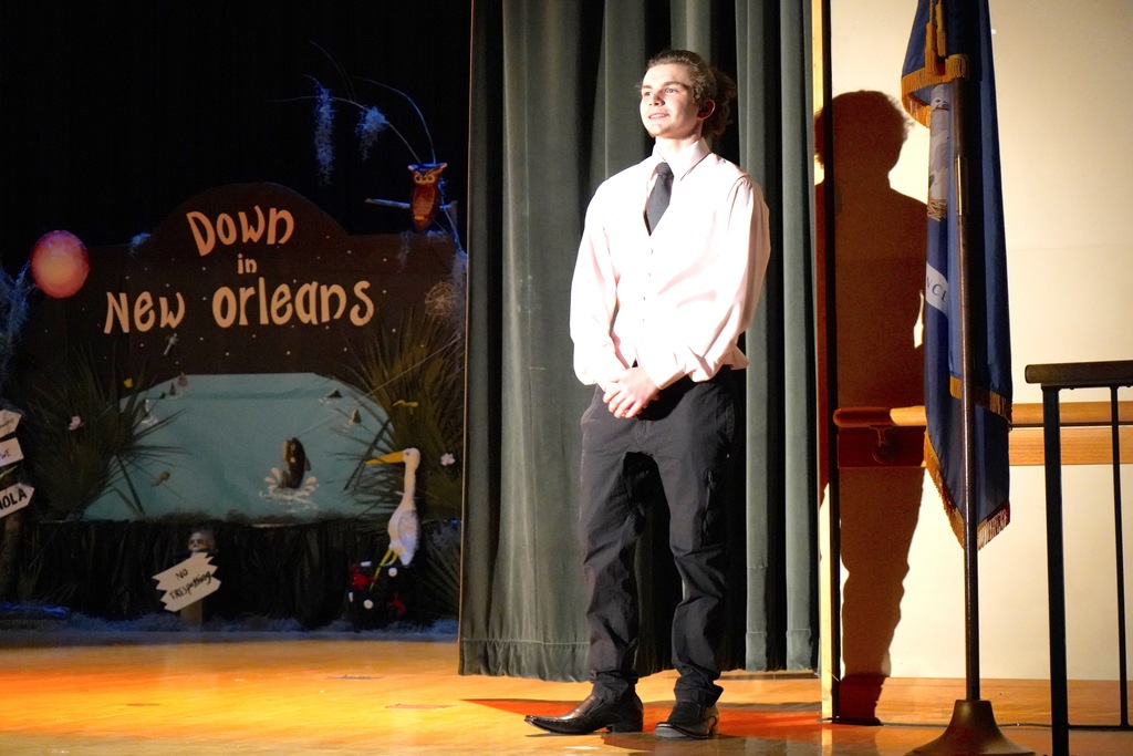 Student posing on stage