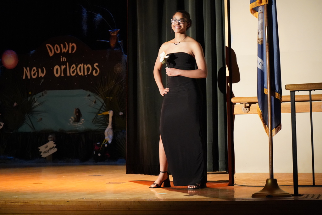 Student posing on stage