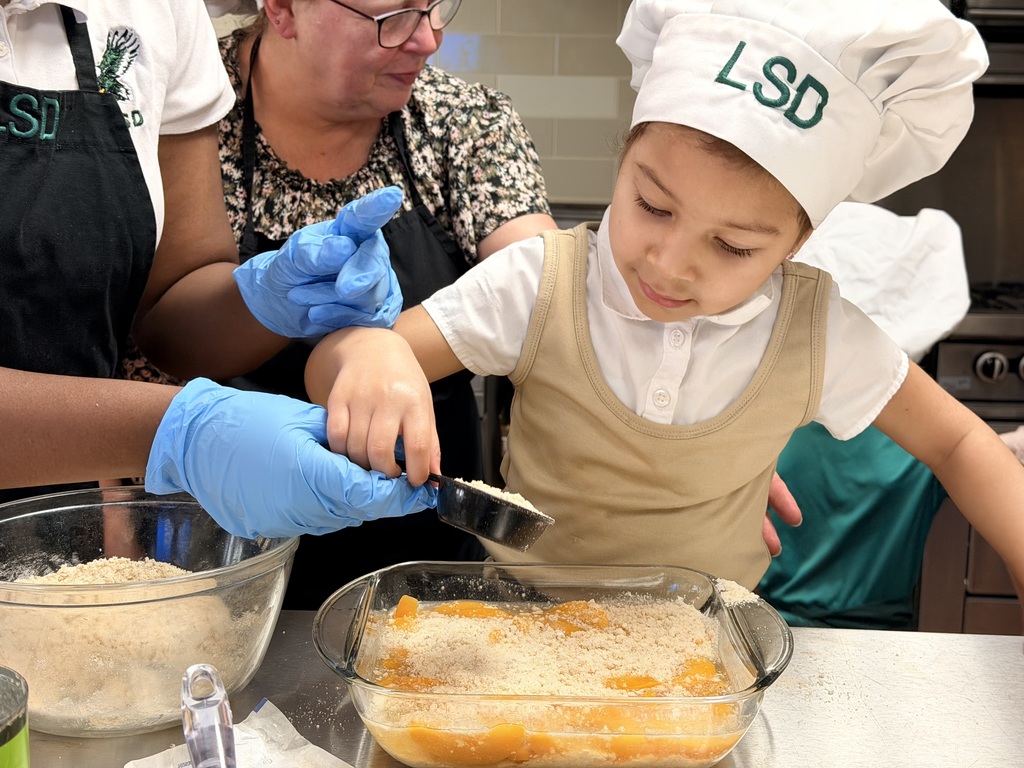 student adding ingredients in a dish