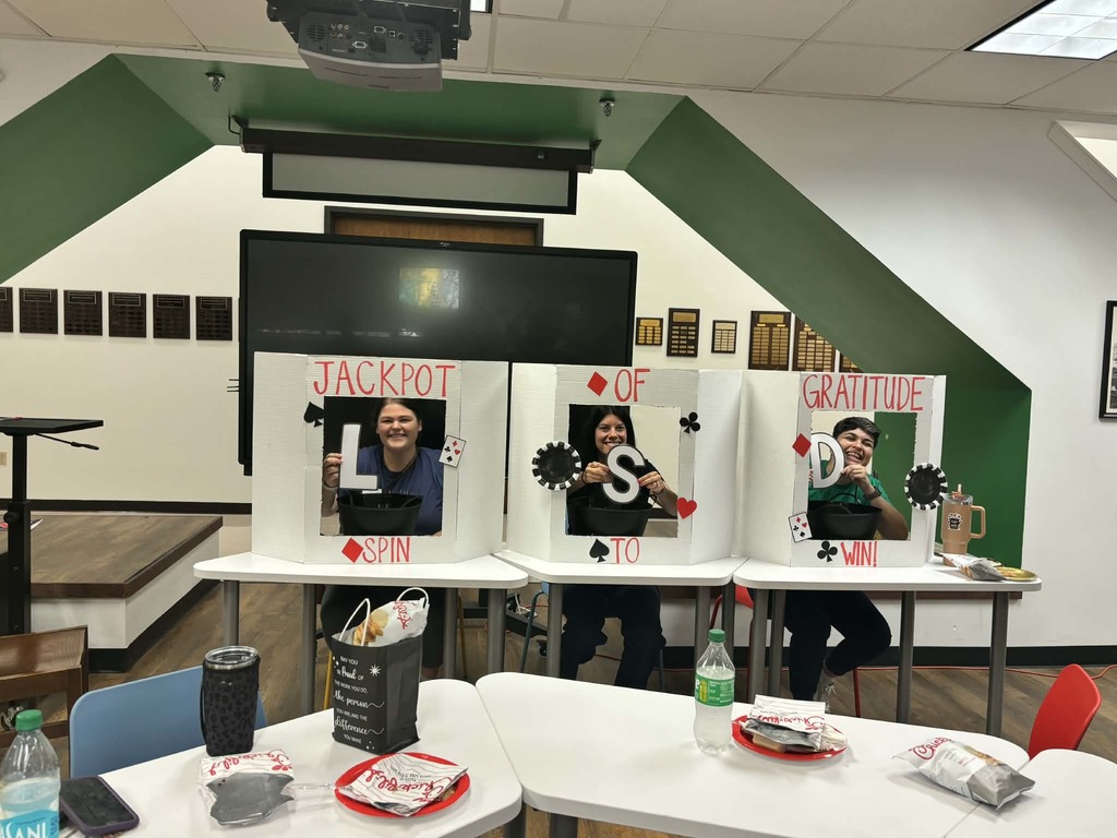 Poster boards that read Jackpot of gratitude, spin to win. Smiling faces are at the center of each board, with letters that read LSD