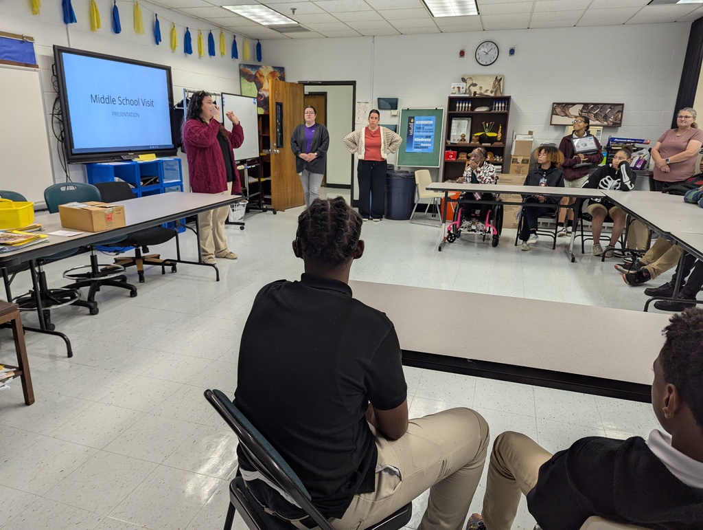 Students sitting at desks for a presentation