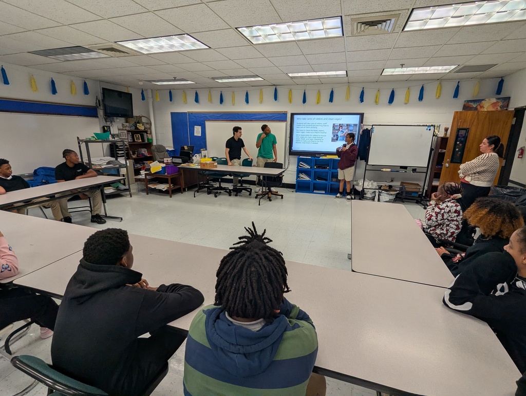Students sitting at desks for a presentation