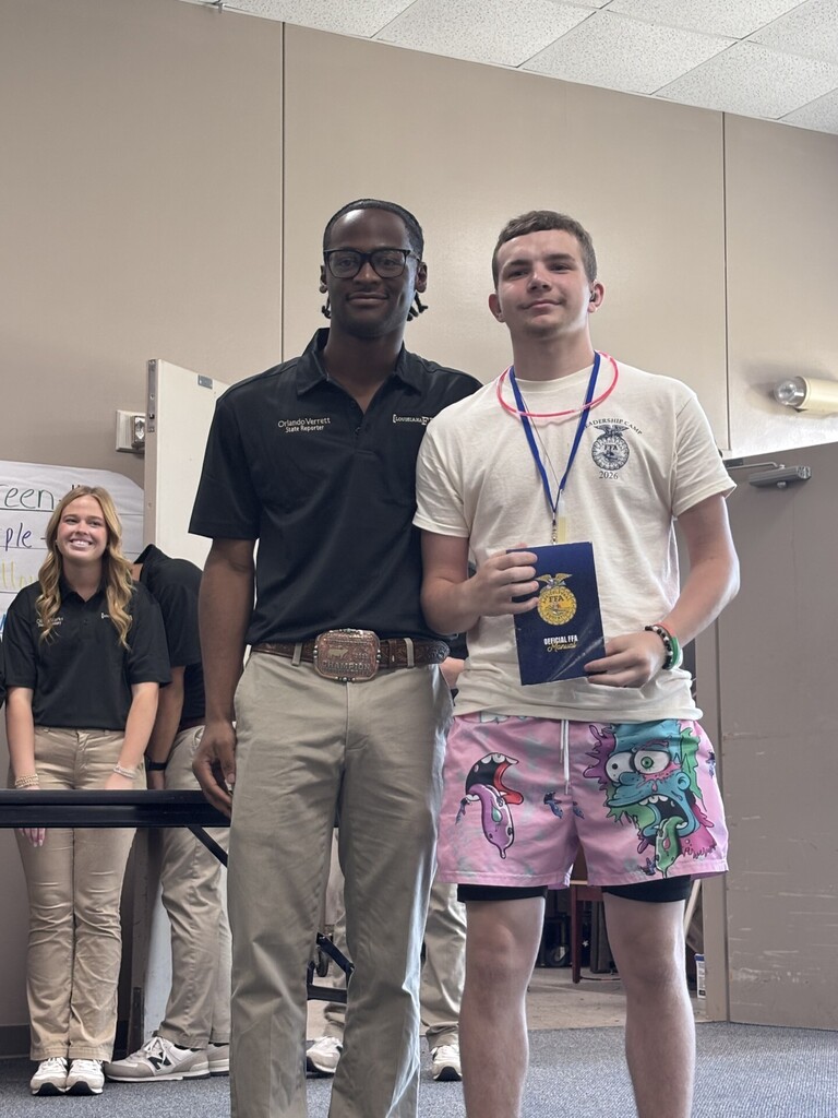 Student holding an award