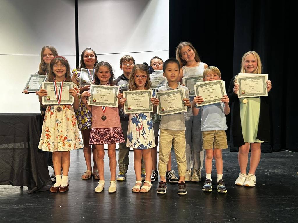 Students holding award diplomas