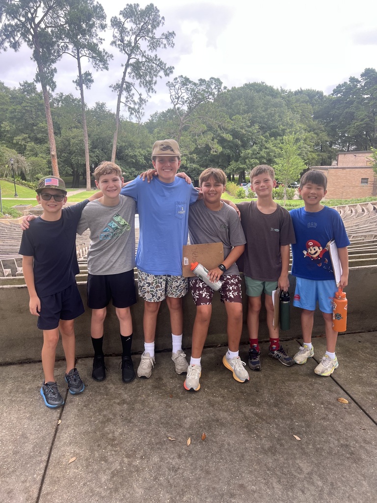 Camp counselor outside with elementary boys