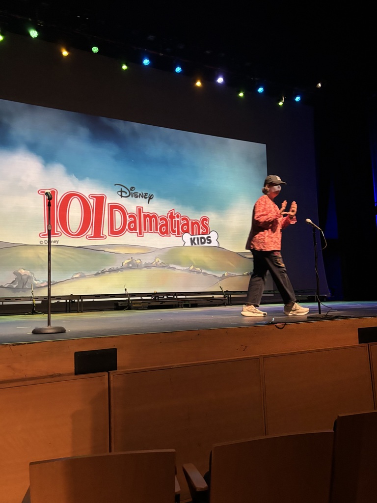 Drama teacher on stage at 101 Dalmatian kids production