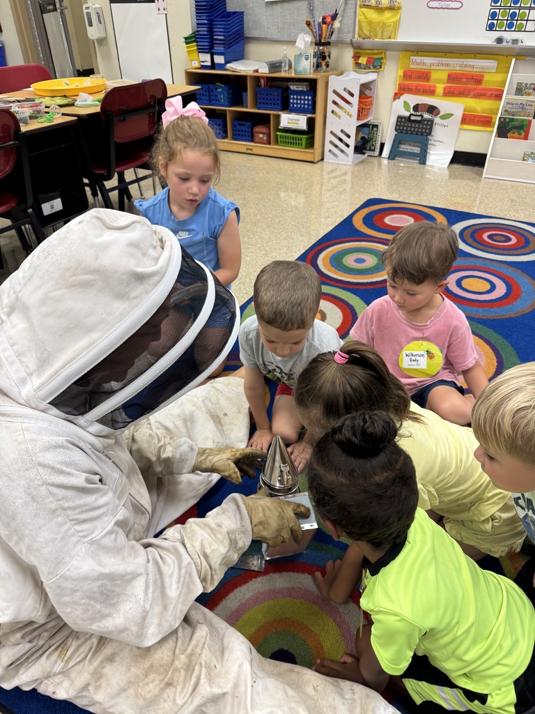 Bee catcher showing elementary students trapped bees