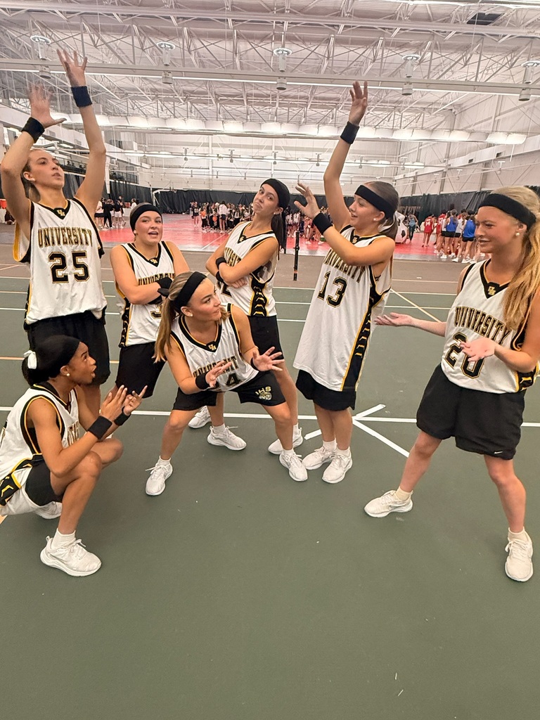 girls wearing unviersity basketball jerseys in a gym