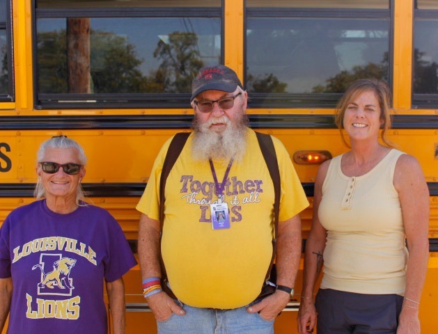 Lousiville Bus Drivers standing in front of the bus