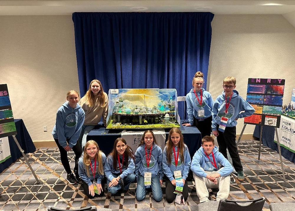 PROUD TO BE A LION! 6th grade Future Cities students showing their biggest smiles while posing in front of their Future Cities model. They were the only 6th grade team to go to Washington D.C.