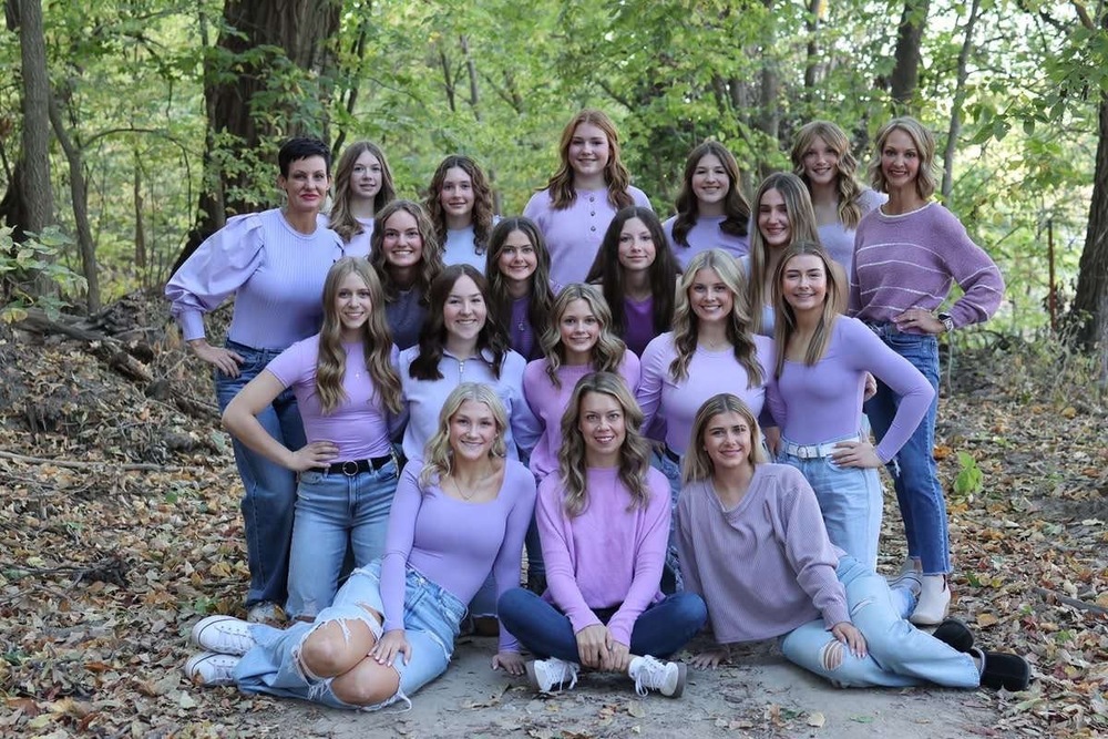ONE LAST GO. The 2024-25 Louisvville Cheer Team takes one last team photo with head coach, Mel Schmitt.