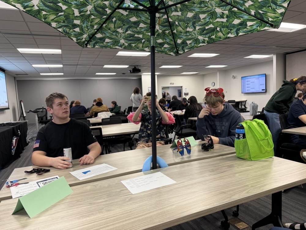 UNDER MY UMBRELLA. High School quizbowl team attends one of their competitions in style. They decided to go all out for this meet and dress in a Hawaiian theme, even including a patio umbrella!