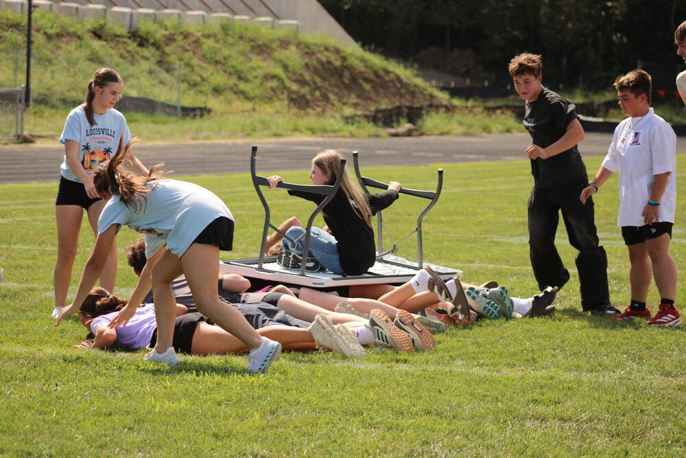 TABLE’S UP. During the homecoming pep rally, the freshman student council members organized a table surfing competition. The competition featured four teams, with students from every grade on each team.