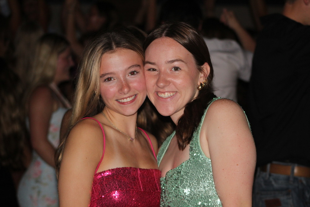 CHEESIN BIG. Knowing that this would be their final homecoming dance, seniors Kayla Bauer and Beatrice Quam pose together for one of their final times.