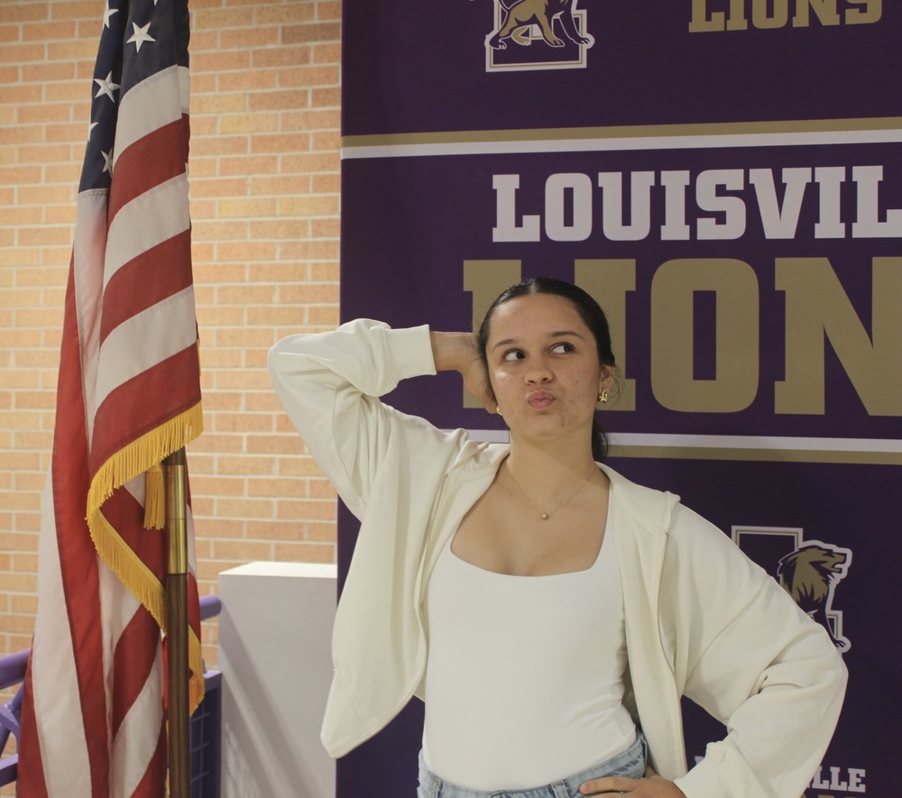 HOME SWEET HOME. Foreign exchange student Junior Amelia Perez Medina stands and poses with the American flag and giggles. “I do really like it here…it’s very different from back at home. But I’ve been sending videos to my friends of my new friends here.”