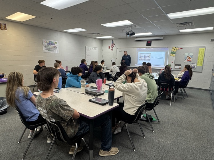 A guest presenter talking with personal finance students in school