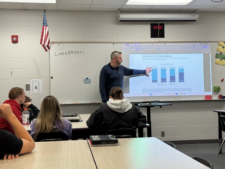 A guest presenter talking with personal finance students in school