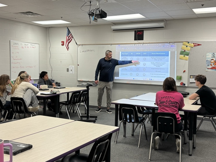 A guest presenter talking with personal finance students in school