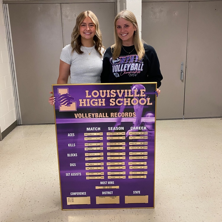 student standing by a record board
