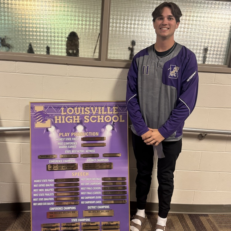 student standing by a record board