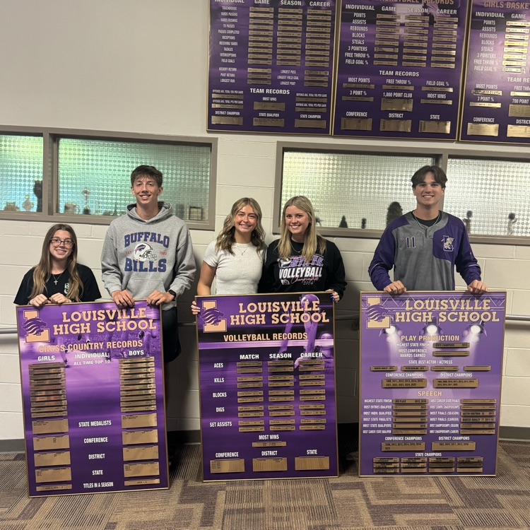 student standing by a record board