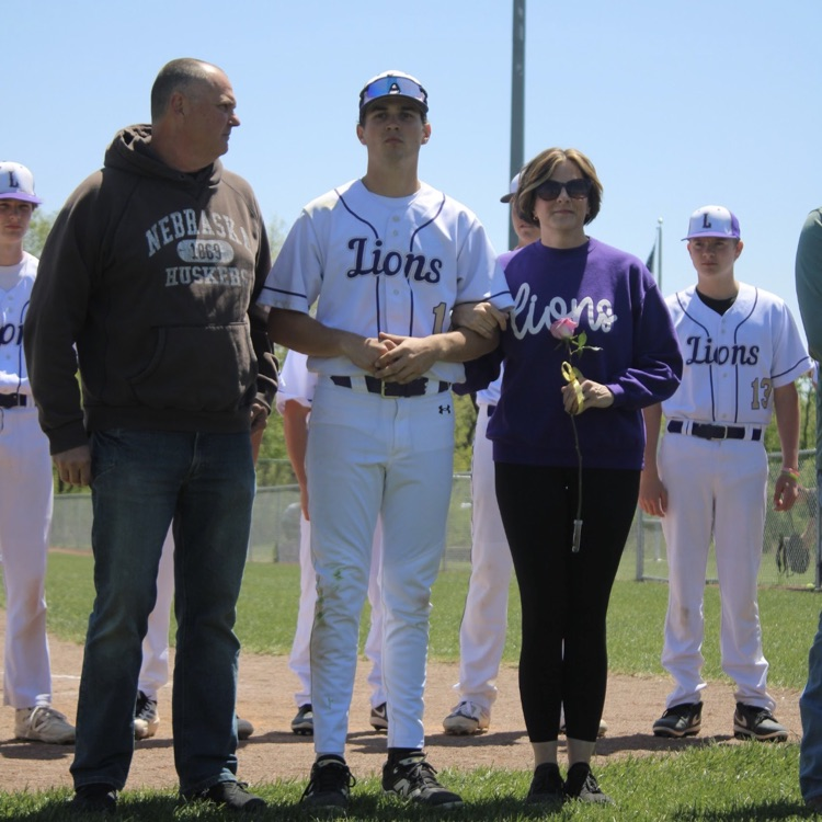 baseball player standing with his parents