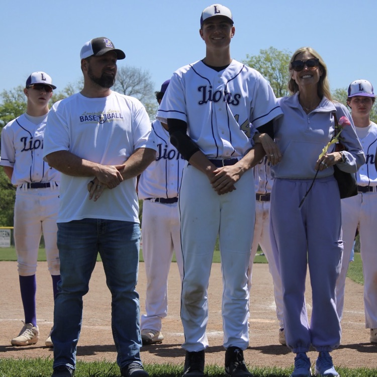 baseball player standing with his parents