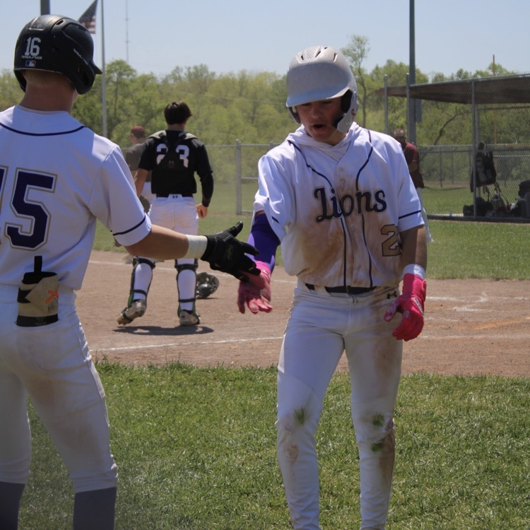 baseball players celebrating a scored run
