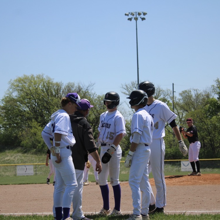 baseball players talking with their coach