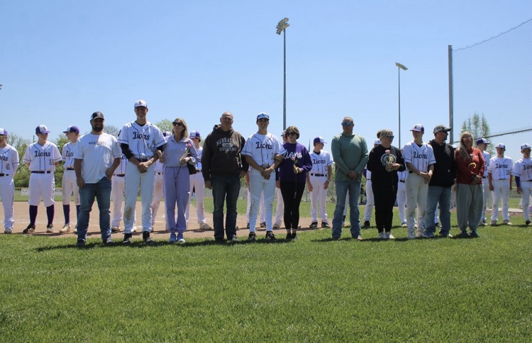 baseball players standing with their parents