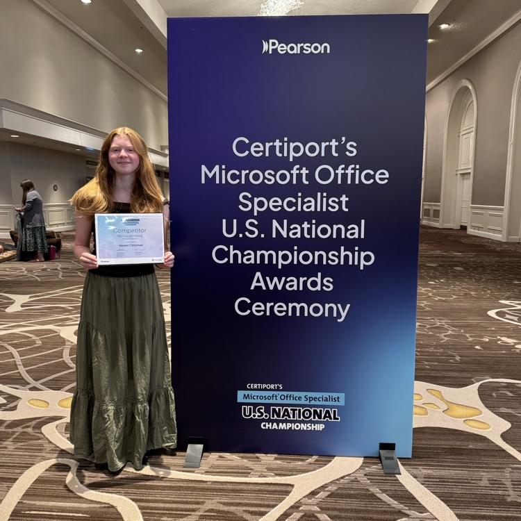 LHS student holding a certificate from the Microsoft national competition